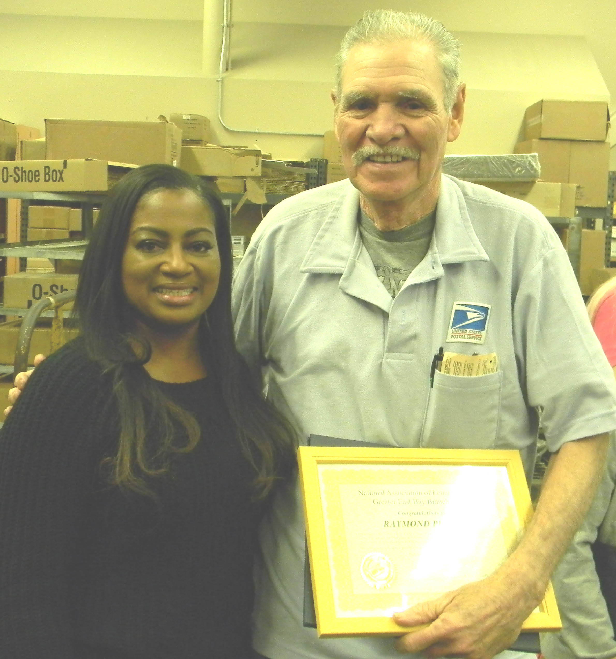 Donna Beth Weilenman/Staff POSTMASTER Crystal Jones was among many Tuesday who congratulated Raymond Perez, who is retiring after 45 years as a letter carrier.