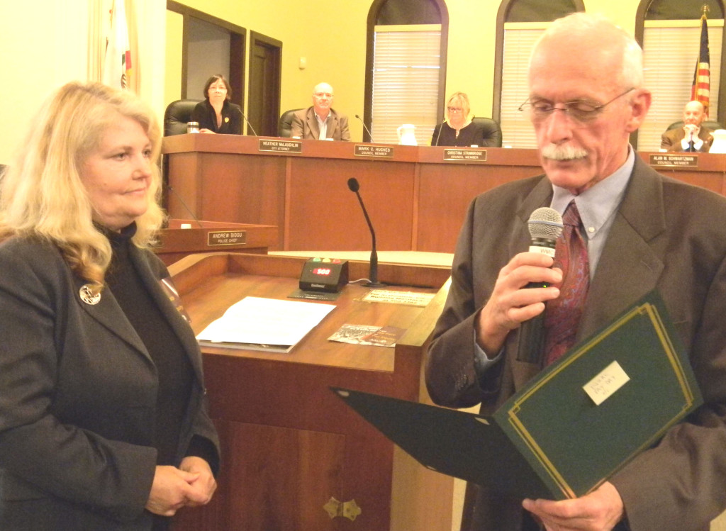 Nancy Parent Smith, president of the AAUW of Benicia and Vallejo, listens last week as Vice Mayor Tom Campbell reads a proclamation recognizing April 8 as Equal Pay Day. Donna Beth Weilenman/Staff