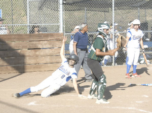 BENICIA’S ALANA COMBES (8) slides home with the go-ahead run in the fourth inning.