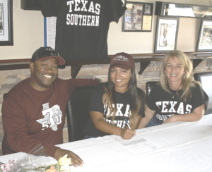 BENICIA SENIOR Chanler Powell (center) signs a letter of intent to play softball for Texas Southern University during a signing ceremony last Saturday at Rookies Sports Bar & Grill in Benicia. Pictured with Chanler are her father (Chris) and mother (Shandrika).