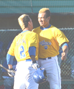 FRED WILLIAMS (right) gets congratulated by teammate Anthony Fellman after hitting a two-run homer in the first inning.