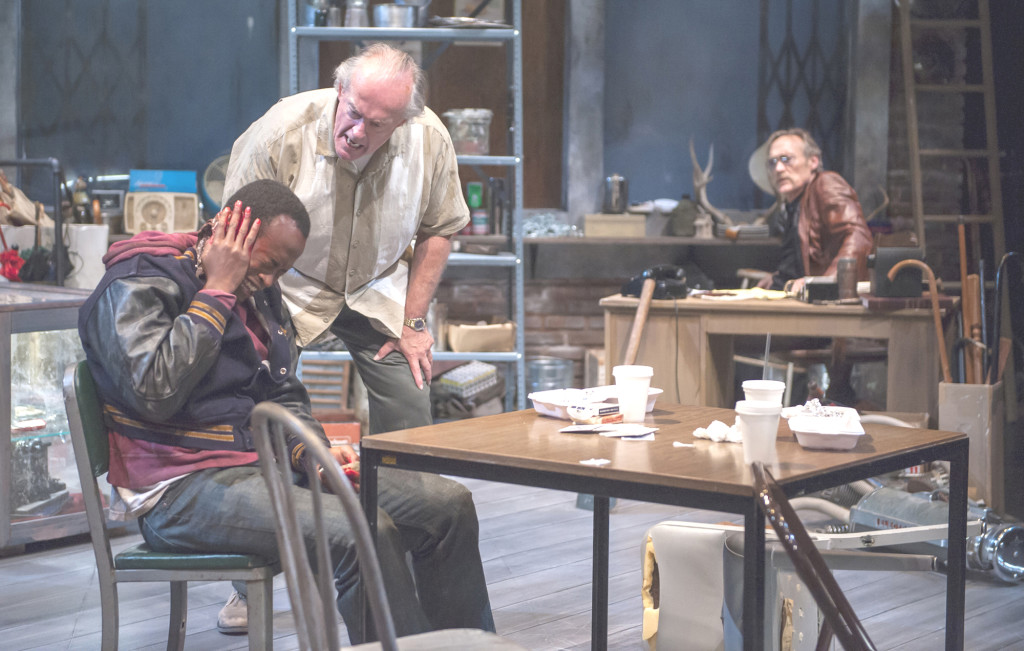 DONNY (Paul Vincent O’Connor, standing) gets caught in the tension between his old pal (James Carpenter as Teach, background) and the new hire (Rafael Jordan as Bobby) in “American Buffalo,” at the Aurora Theatre in Berkeley through July 13. David Allen photos