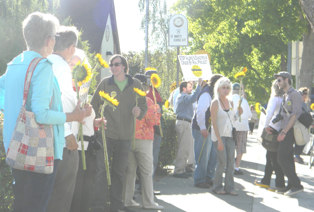 OPPONENTS of Valero’s Crude-by-Rail Project rallied in front of City Hall on Thursday, holding sunflowers to honor the residents of Lac-Megantic, Quebec, Canada, who died in a fiery train accident in 2013. Donna Beth Weilenman/Staff