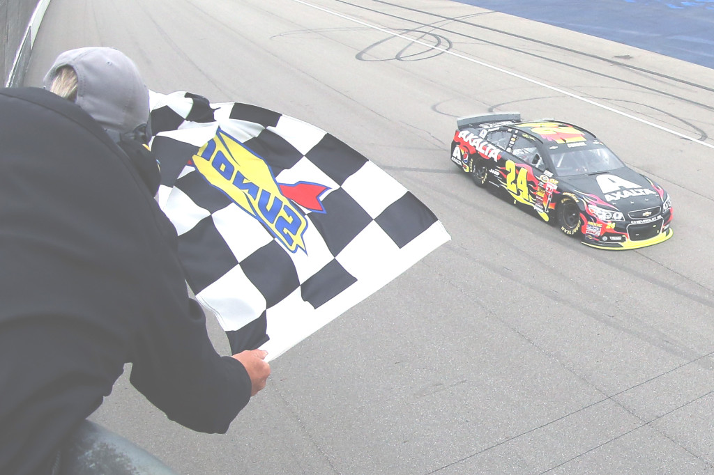 JEFF GORDON takes the checkered flag to win the NASCAR Sprint Cup Series Pure Michigan 400 on Sunday. Brian Lawdermilk/NASCAR via Getty Images