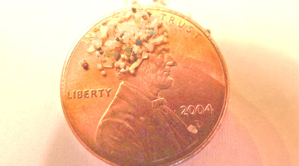 MICROBEADS (on a penny, for scale) are being phased out but not fast enough, many say. marketplace.org