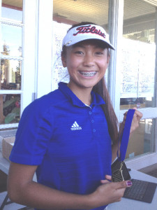 SOFIA YOUNG smiles with the medal she won for taking second place as an individual at Wednesday’s Sierra High Tournament.