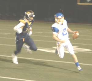 BENICIA QUARTERBACK Riley Pitkin (right) scrambles away from pressure against Inderkum in Friday night’s playoff game in Sacramento.