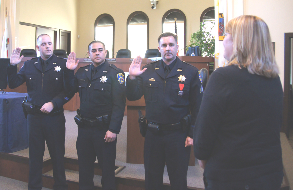 BENICIA POLICE Officers Charles Hendrickson and Ron Tolentino, left to right, are sworn in by City Clerk Lisa Wolfe during a ceremony at City Hall on Tuesday at which Sgt. Mark Hassler was officially promoted. Courtesy photo   