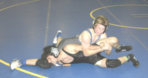 BENICIA’S CODY WILLIAMS (top) takes control over Bethel’s Skylar Edwinson in the SCAC wrestling opener for both school’s Wednesday at Benicia High.