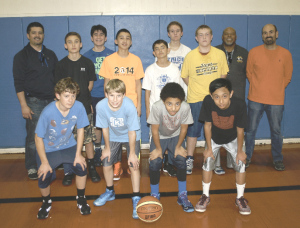 CURRENT PLAYERS and coaches of the St. Dominic’s eighth-grade boys basketball team have gone undefeated three years in a row and are two wins away from a fourth straight unbeaten season. Pictured are (front row from left) Alex Pappas, Kirk Ruble, Mathew McDaniels, Julian Argonza; (middle row) Andrew Maichel, Patrick Dold, Charlie Rose, Nathan Olmes; (back row) coach Luis Morales, Luis Morales Jr., Nolan Fey, coach Shedrick McDaniels and coach Marc Rose. Not pictured are Craig Guila and Dominic Chin.