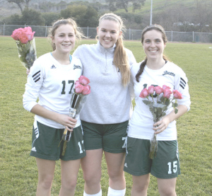 THE ST. PATRICK-St. Vincent High girls soccer team honored seniors Kristina Ruble (left), Kayla Middling (center) and Elliana Levin after Tuesday’s final home game.