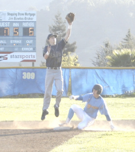 COLE EIGENHUIS of Benicia steals second base as Napa’s Blake Wickersham leaps for the incoming throw.