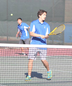 NICK MENJIBAR (foreground) waits for doubles teammate Brian Hung to rip a volley against Bethel.