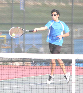 AIDAN MCANINCH of Benicia rips a forehand volley at his Vallejo opponent.