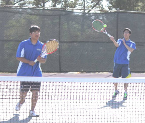 JASON YOO (right) returns a shot against Vallejo while doubles teammate Katsuya Wako (left) looks on.