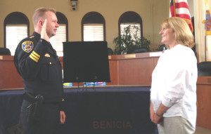 BENICIA POLICE CHIEF ERIK UPSON is sworn in Tuesday by City Clerk Lisa Wolfe. Donna Beth Weilenman/Staff
