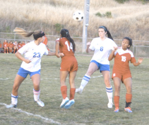 BENICIA HIGH’S Katie Lovelace (8) and Sara Hingley (23) battle Ceres captain Angelica Slater (15) and defender Karina Torrez (14) for a loose ball at Drolette Stadium.
