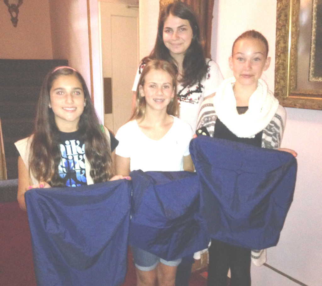 GIRL SCOUTS (from left) Amanda Carvalho, Kaelyn Campbell, Isabel Blaettler and Kiera Sauter show off the new seat covers they sewed for the Majestic Theatre, 710 First St., which will host the final day of the Benicia Film Festival in September. Photos Donna Beth Weilenman/Staff 