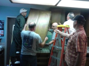 VOLUNTEERS remove cabinets from the home of the Berhels in Benicia; they will be sold at the Habitat for Humanity ReStore in Fairfield. Courtesy Kathy Hoffman