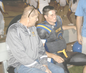 BENICIA QUARTERBACK Riley Pitkin (right) sits with trainer Scott Corbin after suffering a mild concussion against Concord last week. Pitkin is out for Friday’s home game against McClymonds.