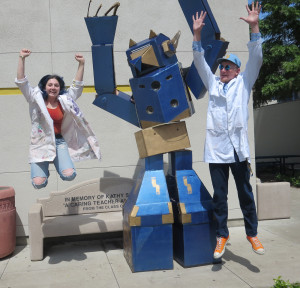 Benicia High senior Rhiannon Johnson (Left) and Advanced Placement art teacher Dan Frazier jump for joy with their creation, Gatobot. The 13-foot robotic panther was designed by BHS art and robotics students. (Photo by Sheridan Lugo)