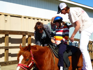 Amy gets some help mounting her pony before a lesson at Cornerstone Equitherapy in Napa. (Photo by Elizabeth Warnimont)