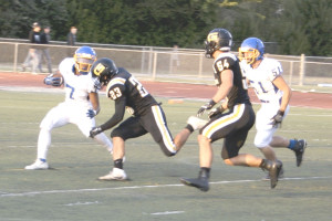 BENICIA RUNNING back Cavon Etter (7) has nowhere to go as Granada’s Tai Phan (23) moves in for a tackle.