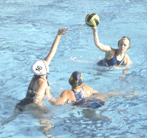 CHLOE BONINI (top right) tries to get the ball over Franklin’s defense as Lady Panther teammate Kaela Peterson (12) sets a screen.