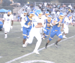 BENICIA RUNNING BACK Aaron Jenkins (34), just called up to the varsity this week, breaks off a big run against Pinole Valley.