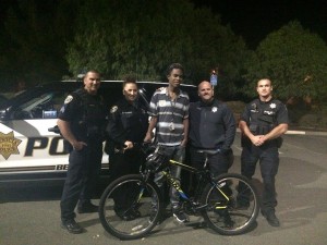 Jourdan Duncan (Center) received a bike from the Benicia Police Officers Association. Duncan lives in Vallejo and works at Pro-Form Laboratories in the Industrial Park, which he used to walk to every night following the breakdown of his car. Through a crowdfunding campaign, Duncan was able to buy a car and enroll at Solano Community College. (Photo courtesy of Benicia Police Department)