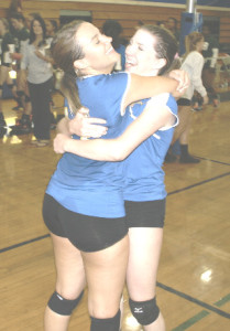 BENICIA HIGH’S Karah Fisher (left) and Emily Maher celebrate after the Lady Panthers beat Vanden in five sets to move into first place.