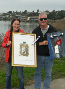 A couple poses with the free art they found last Friday. (Photo by Randy Bernard)