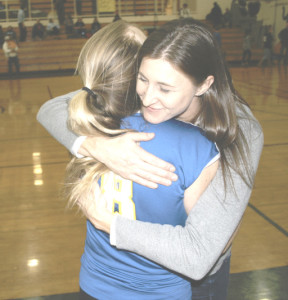 BENICIA HIGH varsity volleyball coach Jamie Hadenfeldt gets a goodbye hug from senior Semele Hargis (8) after the Lady Panthers were eliminated from the Sac-Joaquin Section playoffs.